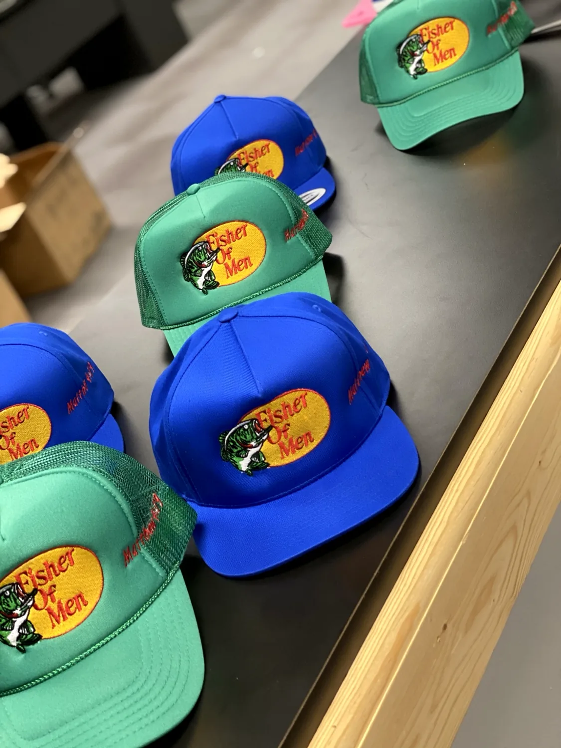 Collection of embroidered green and blue caps