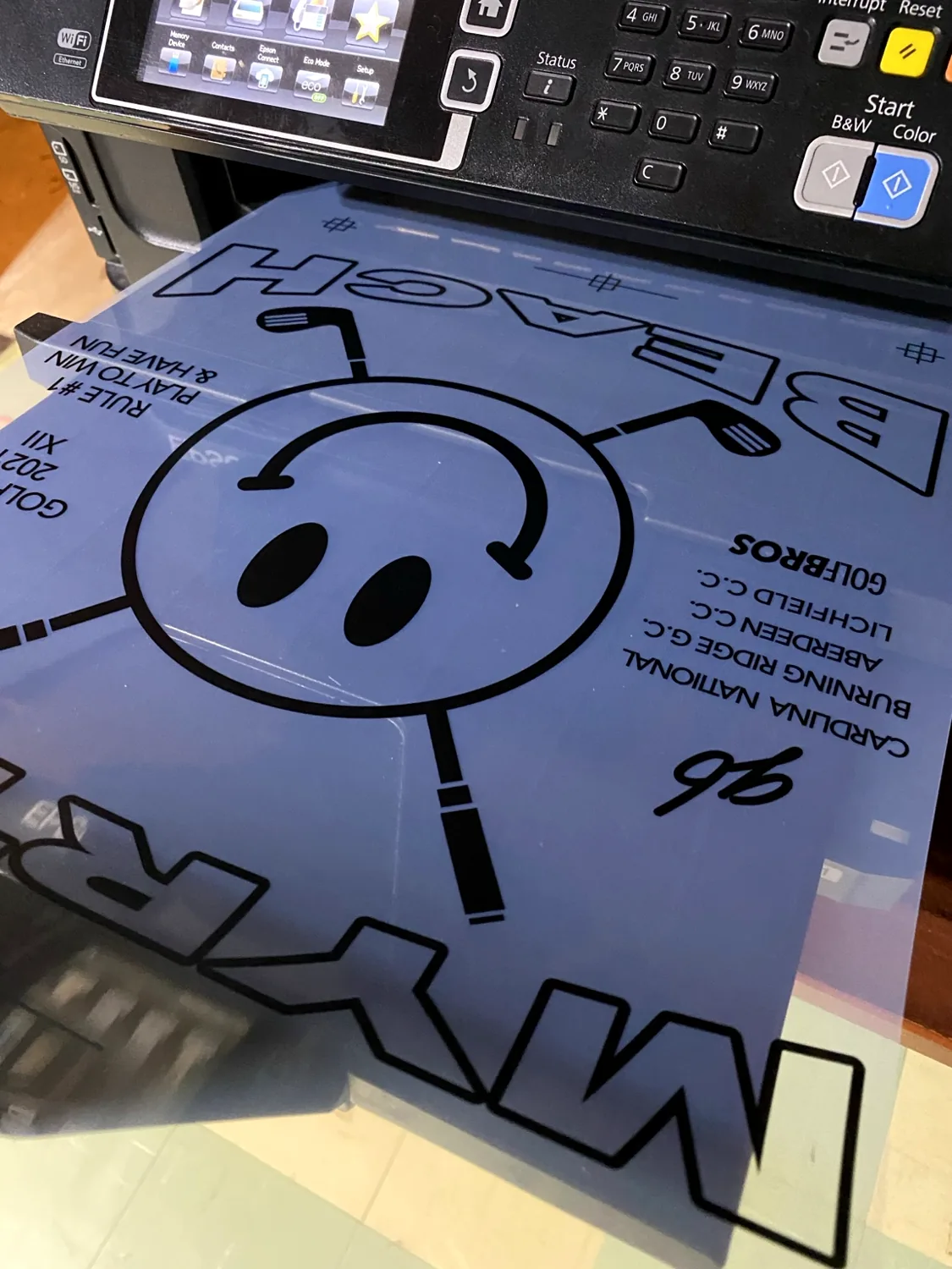 Production artwork film coming from a printer