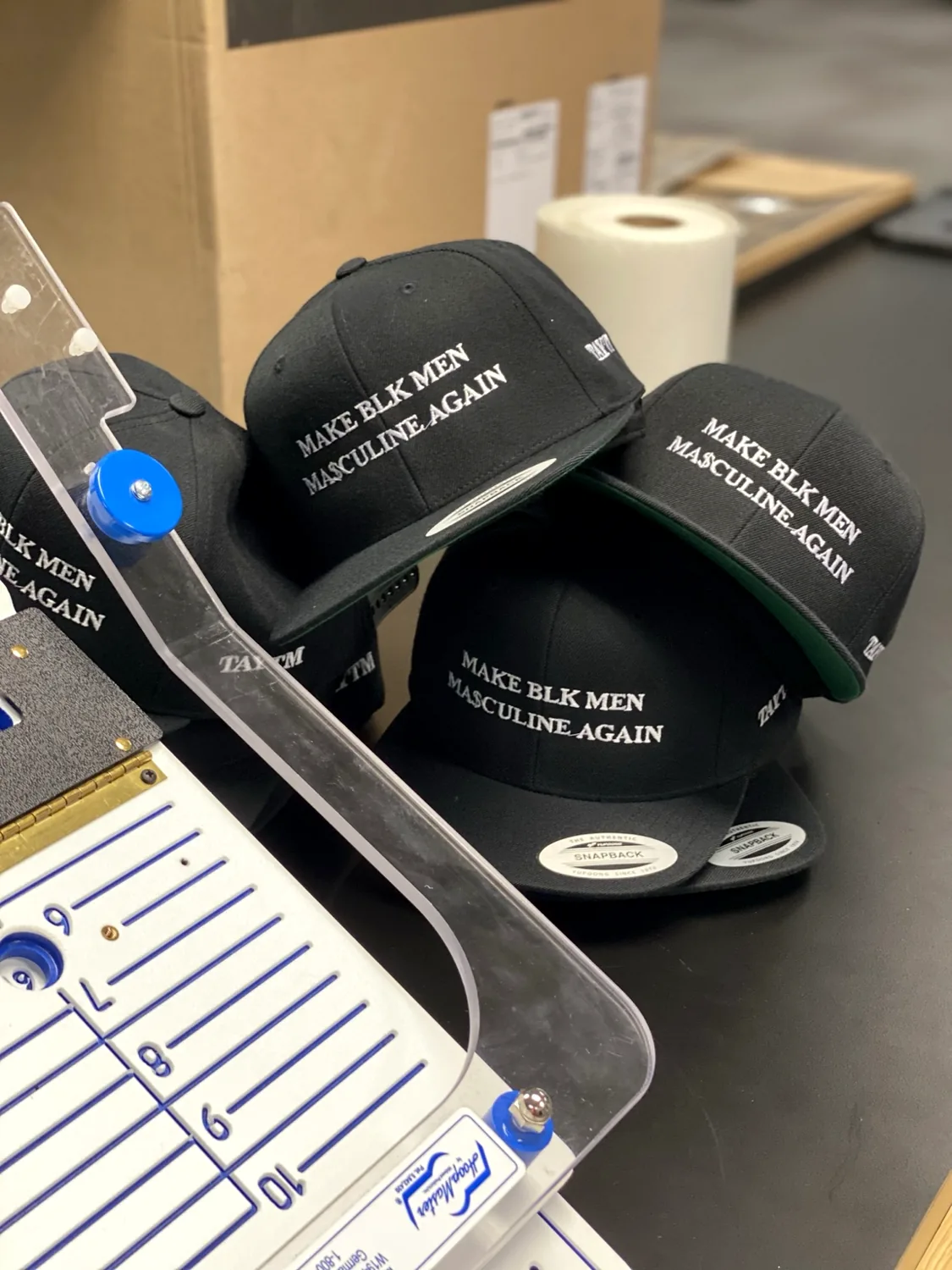 Black caps with white embroidered lettering
